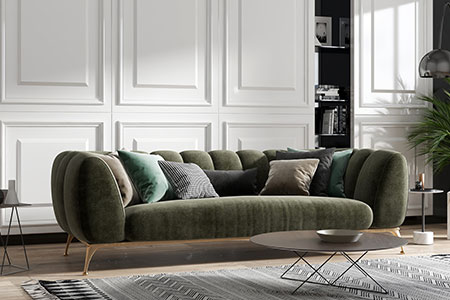 Trendig soffa i grön sammet i vardagsrum med stuckaturer